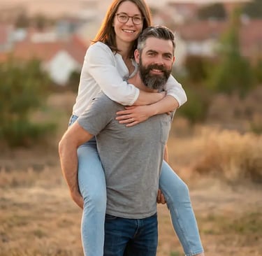 Couple doing piggyback pose in Mikulov vineyards at golden hour with town backdrop