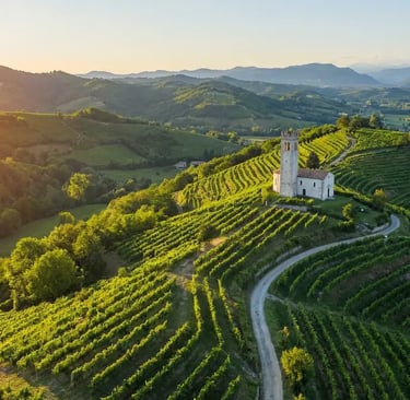 Aerial view of UNESCO Prosecco Hills with ancient church tower surrounded by steep green vineyards