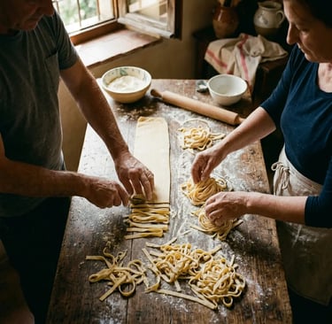Hands making fresh tagliatelle pasta on flour-dusted farmhouse table during Amalfi cooking class