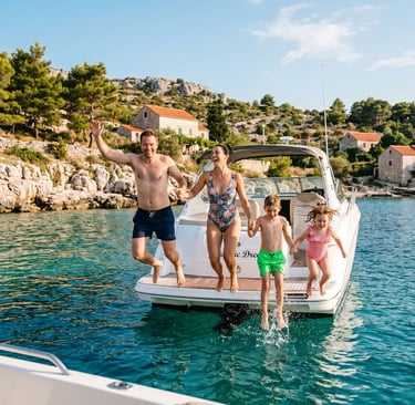 Family jumping off private speedboat into turquoise water, Dalmatian coast, Croatia