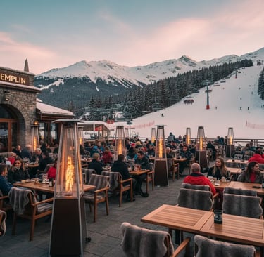 The spacious outdoor terrace of Le Tremplin restaurant in Courchevel, featuring modern fire heaters 