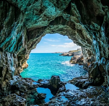 Rocky sea cave arch opening to turquoise Adriatic Sea near Monopoli