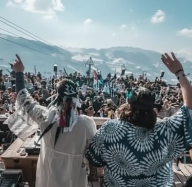 Outdoor winter music festival and crowd atmosphere at a mountain lodge.