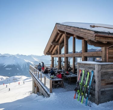 The traditional wooden chalet exterior of Le Cap Horn restaurant in the French Alps, featuring skis