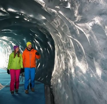 Couple exploring blue ice tunnels in Mer de Glace Ice Cave, Chamonix.