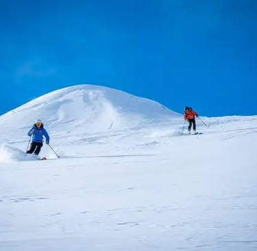 Skiers relaxing with panoramic views at Stubai Glacier.