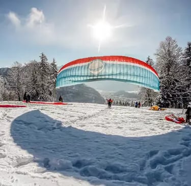 Paragliding wing laid out on snow at Amisbühl launch site ready for winter takeoff