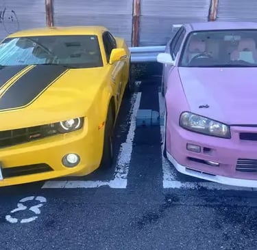 Fast and Furious replica cars: Yellow Camaro and Pink Skyline in Tokyo.