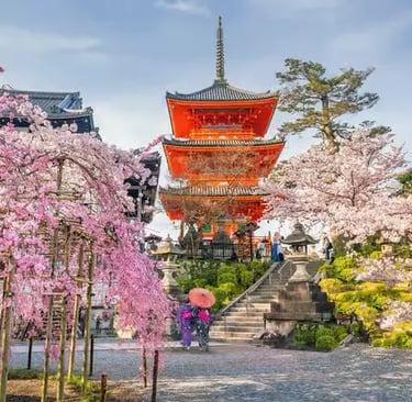 Kiyomizu-dera Temple pagoda during cherry blossom season in Kyoto.