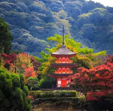 Scenic red pagoda nestled in Kyoto mountains with autumn colors, private tour destination.