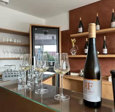 A bottle of premium Gruner Veltliner wine and glasses on a bar in Wachau Valley.