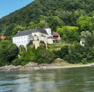 Medieval castle perched on a rock overlooking the Danube River in Austria's Wachau Valley.