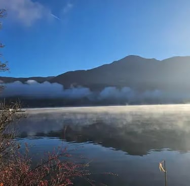 Misty morning atmosphere on Lake Zell with mountains Zell am See Austria.