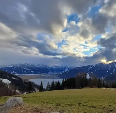 Scenic view of Lake Zell and snowy Alps during Zell am See Austria day trip.