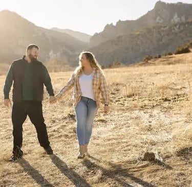 Couple walking on Boulder mountain trail during professional Colorado photoshoot session