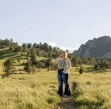 Family photoshoot in Boulder Colorado meadow with Rocky Mountains in background