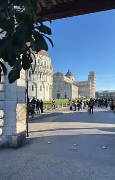 Walking into Pisa’s Square of Miracles with the Cathedral and Leaning Tower ahead