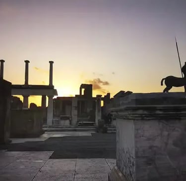 Silhouette of centaur statue at Pompeii Forum during golden sunset, ancient columns