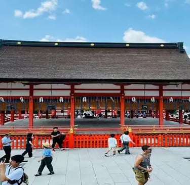 Crowds of tourists visiting the main hall of Fushimi Inari shrine in Kyoto