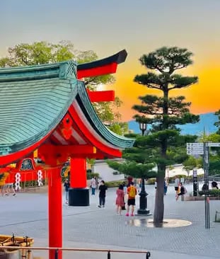 Red torii gate at Fushimi Inari shrine in Kyoto at golden sunset