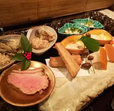 Elegant kaiseki appetizer spread with multiple small dishes on a stone plate, Kyoto cuisine