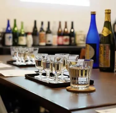 Sake tasting flight with multiple glasses and bottles at Fushimi district brewery