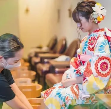 Kimono-dressed woman receiving foot spa treatment from therapist in Kyoto Japan