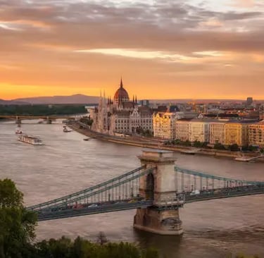 Aerial view of Budapest Parliament and Chain Bridge over the Danube at dramatic sunset