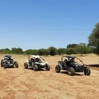Three off-road buggies parked on sandy trail in Puglia countryside