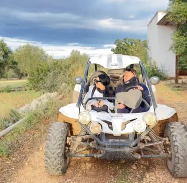 Couple riding white off-road buggy on rural dirt track in Apulia, southern Italy