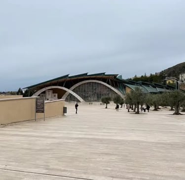 Padre Pio Pilgrimage Church exterior San Giovanni Rotondo with stone cross and olive trees