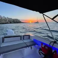 Golden sunset over Adriatic Sea viewed from private boat deck, Puglia Italy