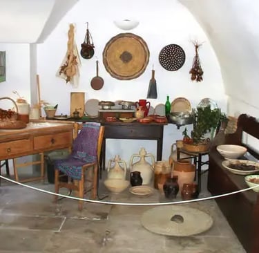 Authentic interior of traditional trullo home with rustic kitchen and artifacts in Alberobello