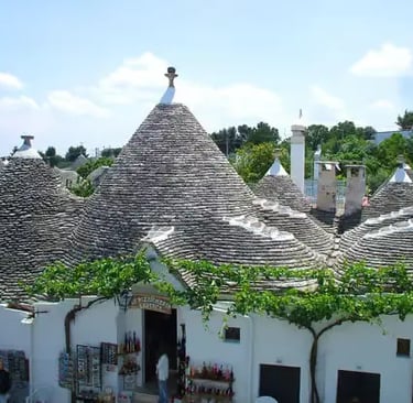 Historic stone trulli houses with conical roofs in Alberobello UNESCO site, Puglia Italy