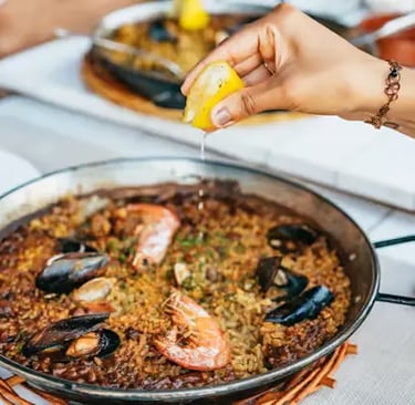 Fresh seafood paella with lemon served as part of 3-course meal in Tossa de Mar