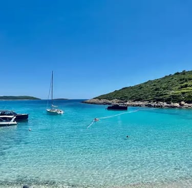Turquoise Blue Lagoon cove at Drvenik Veli Croatia with sailboats and green hillside