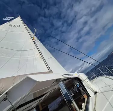 Bali catamaran under full sail with blue sky on Mediterranean sailing holiday