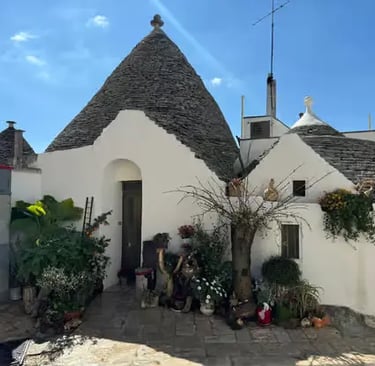 Traditional trullo dwelling with conical limestone roof and whitewashed walls in Alberobello