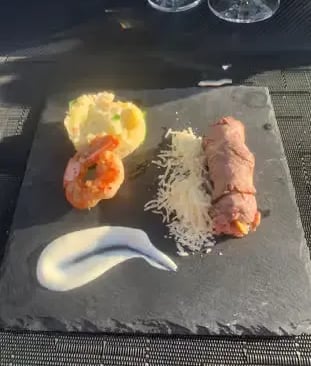 Prawn and stuffed meat main course served on slate at sky dining Dubrovnik