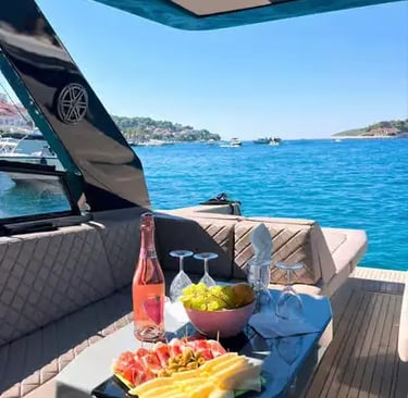 Luxury speedboat deck with rosé wine, fresh fruit and snacks overlooking turquoise Pakleni Islands sea