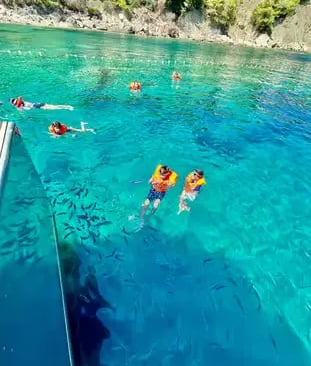 Snorkelers swimming in transparent turquoise water at Blue Lagoon Drvenik Veli Croatia