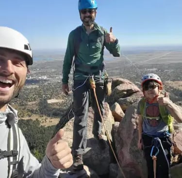 Happy climbers with professional guide celebrating successful Flatiron climb in Boulder