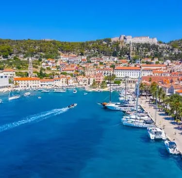 Aerial view of Hvar harbor with luxury yachts and Fortica fortress on the hilltop