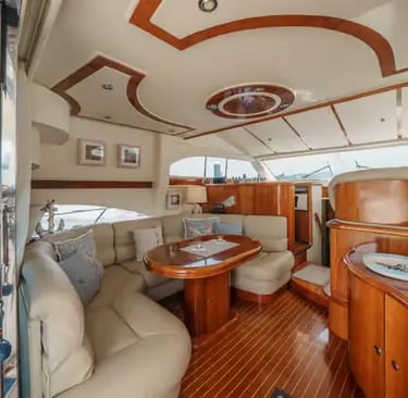 Elegant saloon interior of a Douro cruise yacht with cream sofa and mahogany wood finishes.