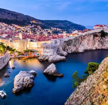 Dubrovnik old town walls and harbor illuminated at dusk, Croatia