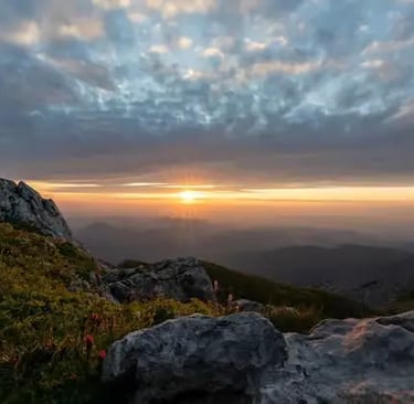 Sunrise over Tyrolean Alps from Umbrüggler Alm hiking trail showing dramatic clouds and rocky terrain on beginner hike 