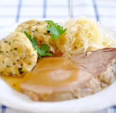 Traditional Tyrolean bread dumplings and roasted meat served at Innsbruck mountain huts along Nordkette hiking tour route