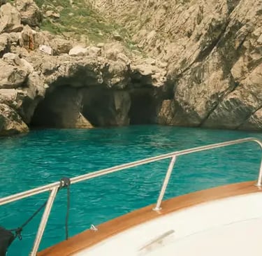 View of Green Grotto turquoise water and cave entrance from the bow of a traditional Caprese gozzo.