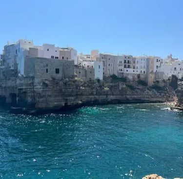 Polignano a Mare whitewashed old town perched on limestone cliffs above Adriatic Sea