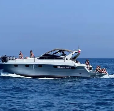 Small-group tour boat cruising the open Tyrrhenian Sea along the Amalfi Coast